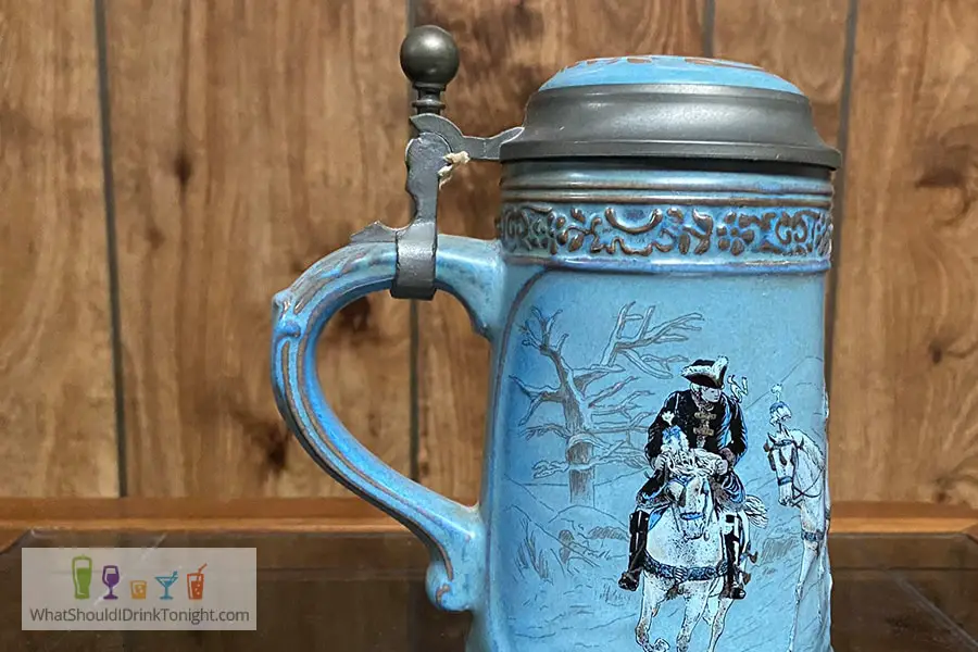 Baby blue beer stein with man riding a horse topped with a lid